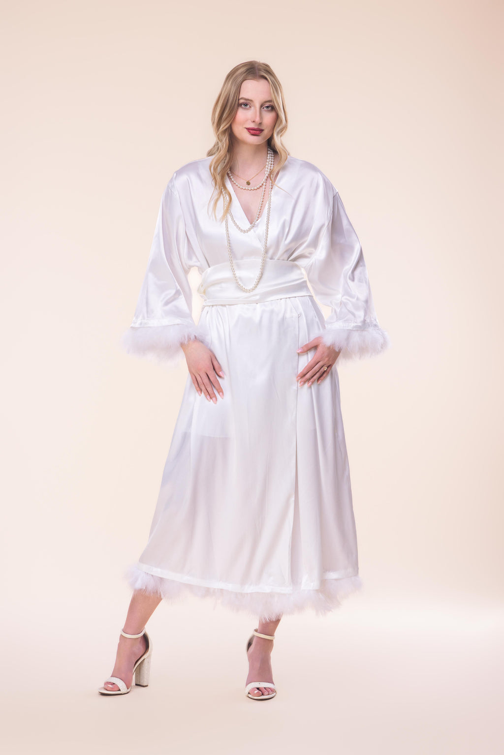 Woman wearing a white dress with a plain background