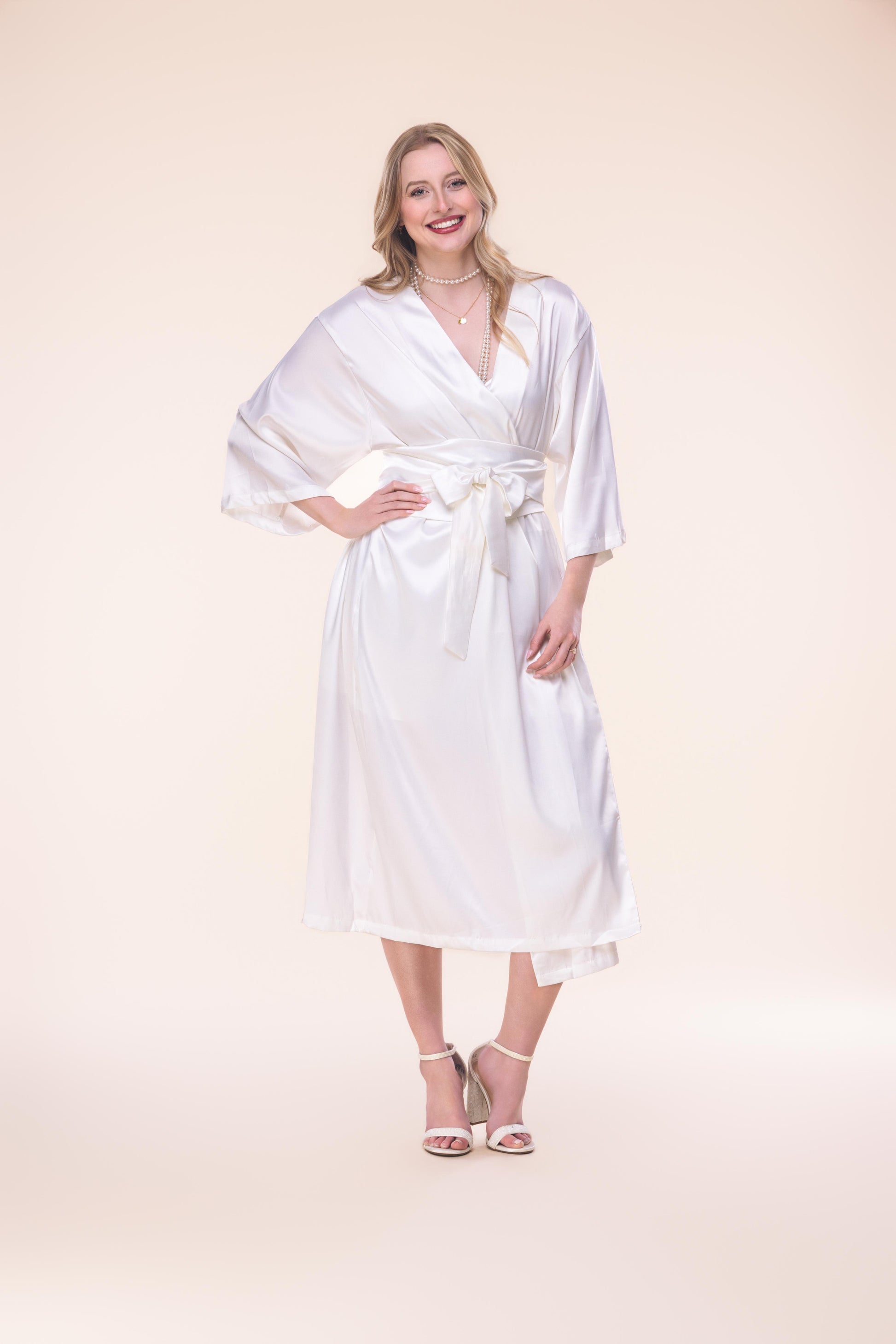 Woman wearing a white robe on a beige background