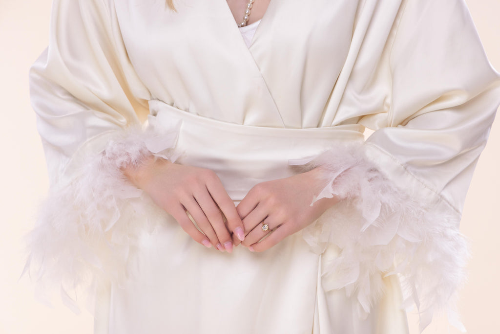 Close-up of a person wearing a white dress with a soft focus background
